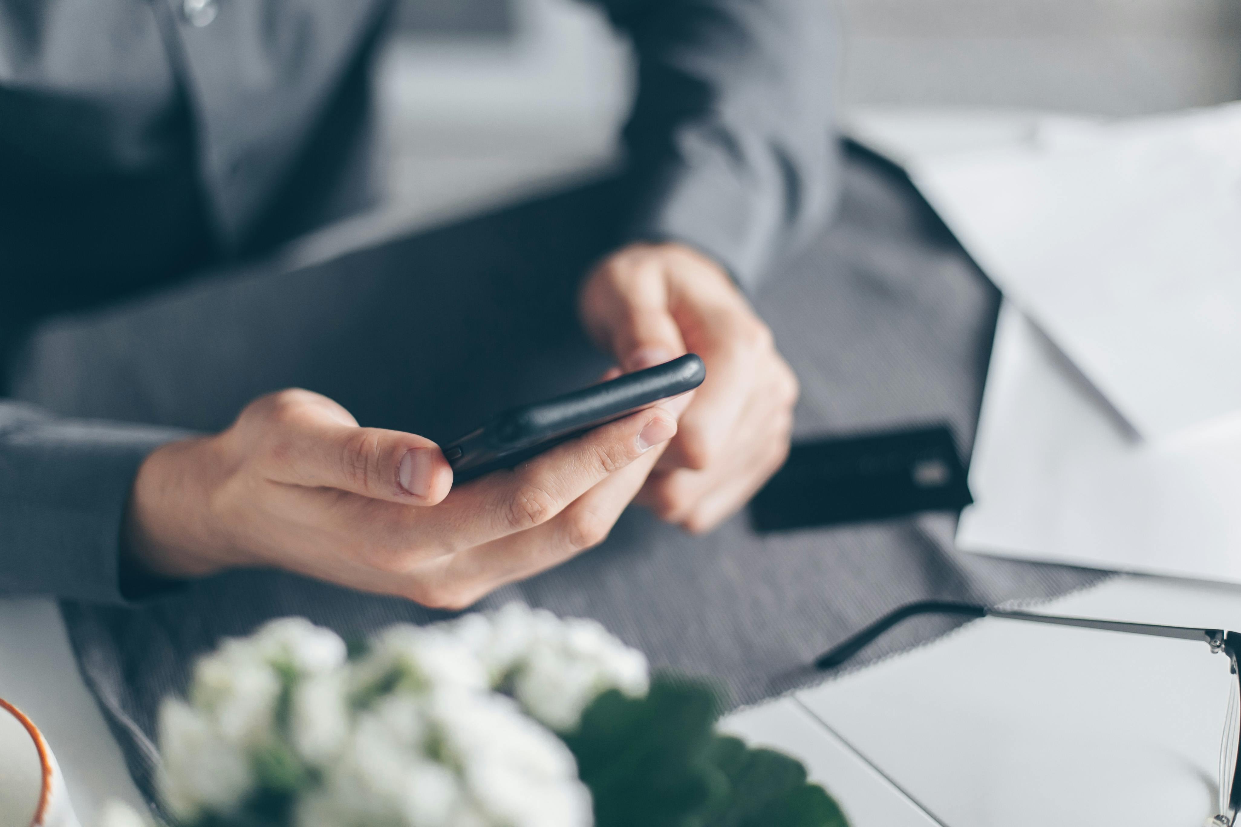 Business owner using a smartphone to complete an online EIN registration application quickly and efficiently.