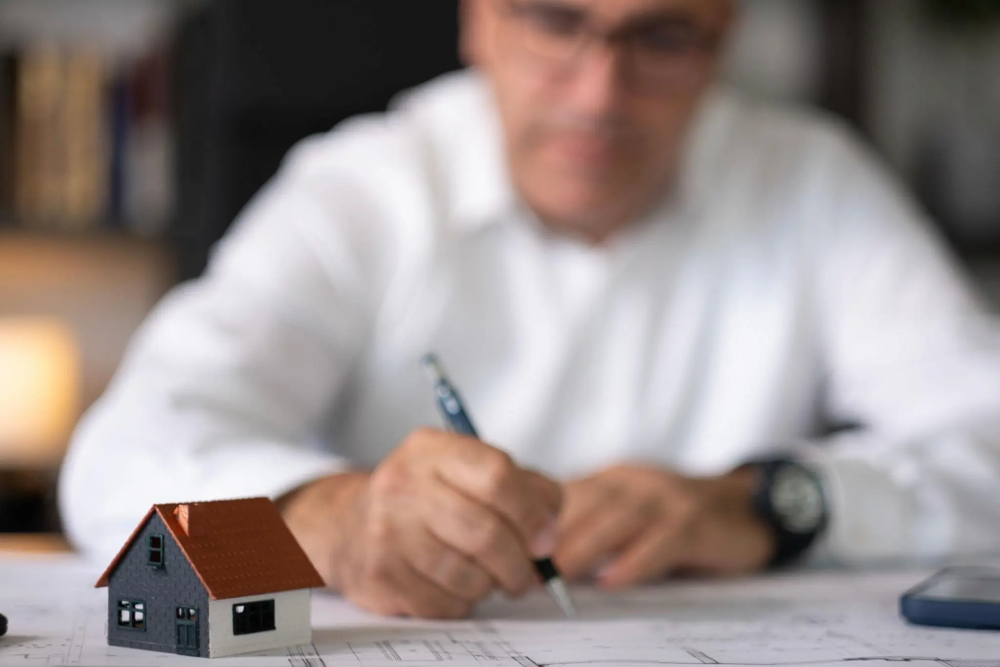 Professional investor in a bright, modern office using a laptop for a Florida foreign entity registration.