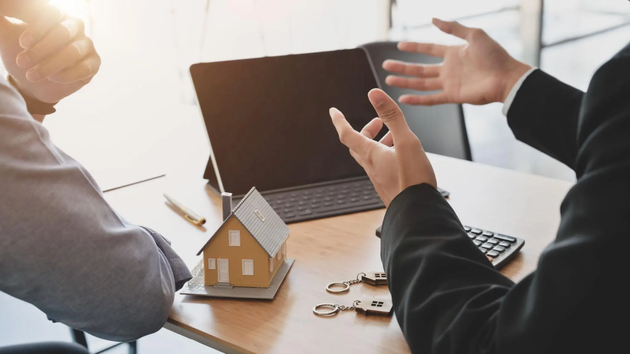Real estate professional signing paperwork by a model house to resolve a Florida entity status inactive.