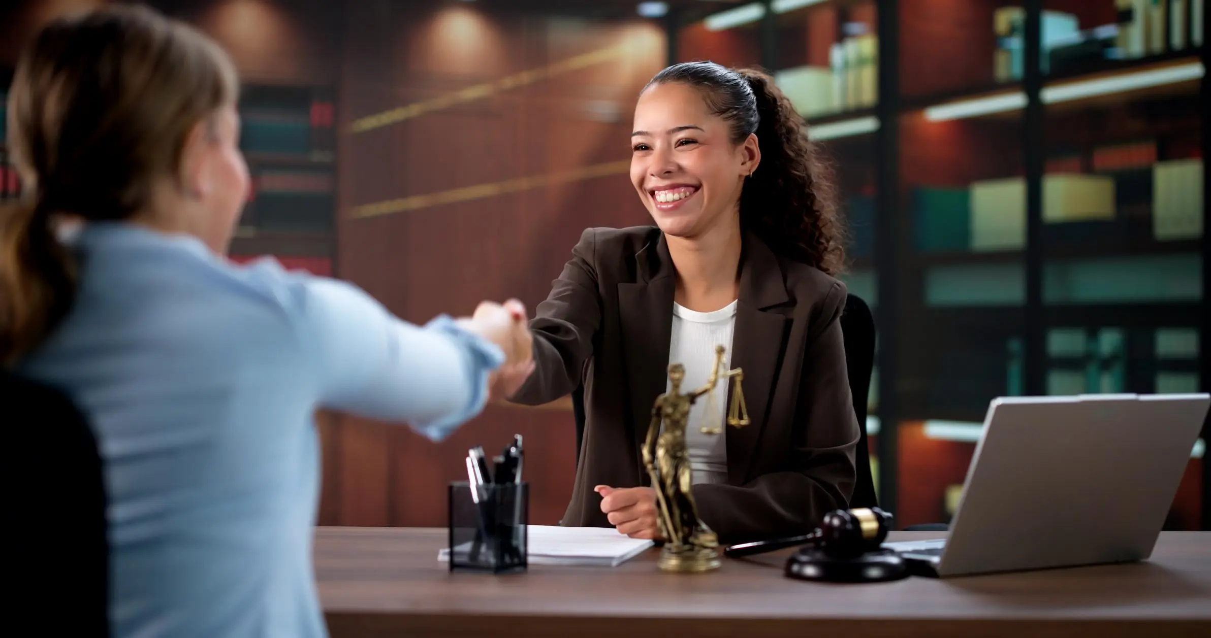 Smiling attorney with a justice scale shaking hands with a client to file Articles of Amendment in Florida.